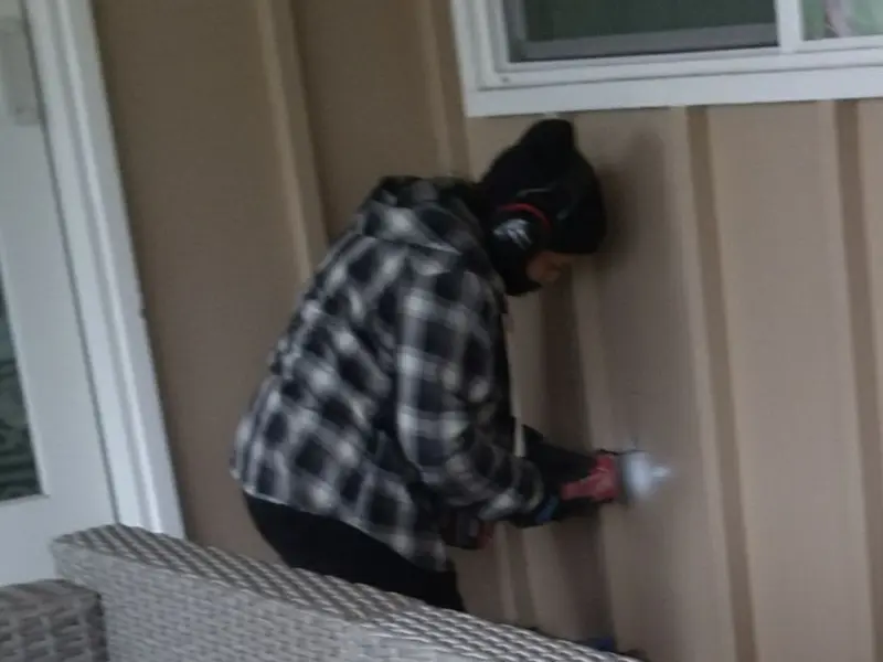 Professional electrician installing an exterior outlet in Ferguson